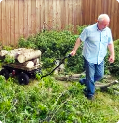 Man hauling logs on electric pull cart